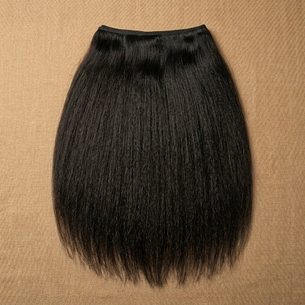 Adéorí Yaki virgin hair extension bundle flat lay on earthy surface