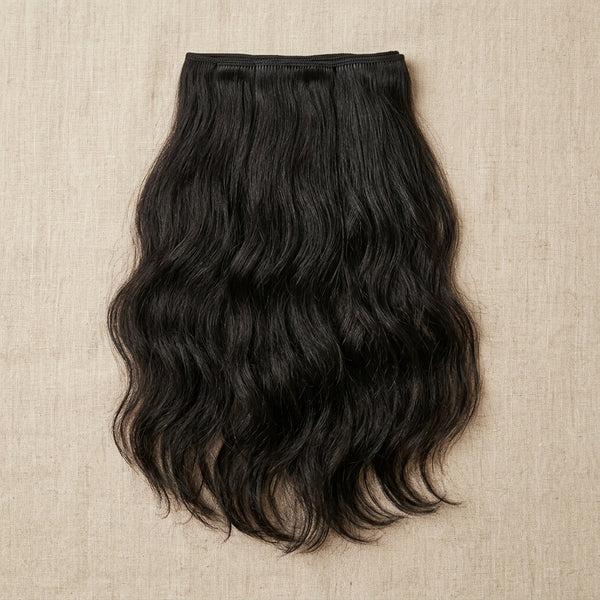 Adéorí Loose Wave virgin hair extension bundle flat lay on earthy surface