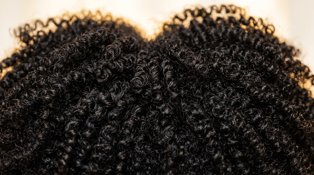 Two sections of 4C coily hair blending seamlessly into one weft, no heat used
