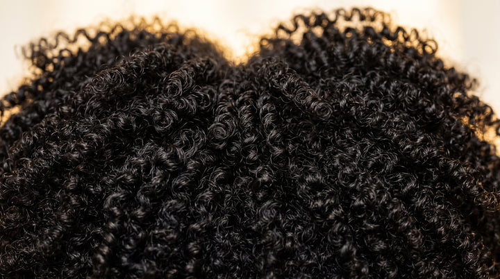 Two sections of 4C coily hair blending seamlessly into one weft, no heat used