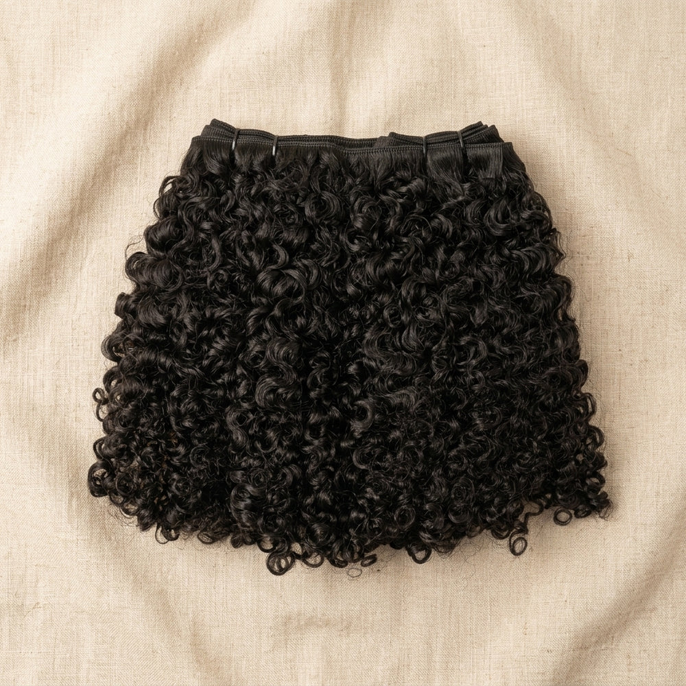 Adéorí Burmese Curly virgin hair bundles — 100% human hair flat lay