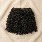 Adéorí Burmese Curly virgin hair bundles — 100% human hair flat lay