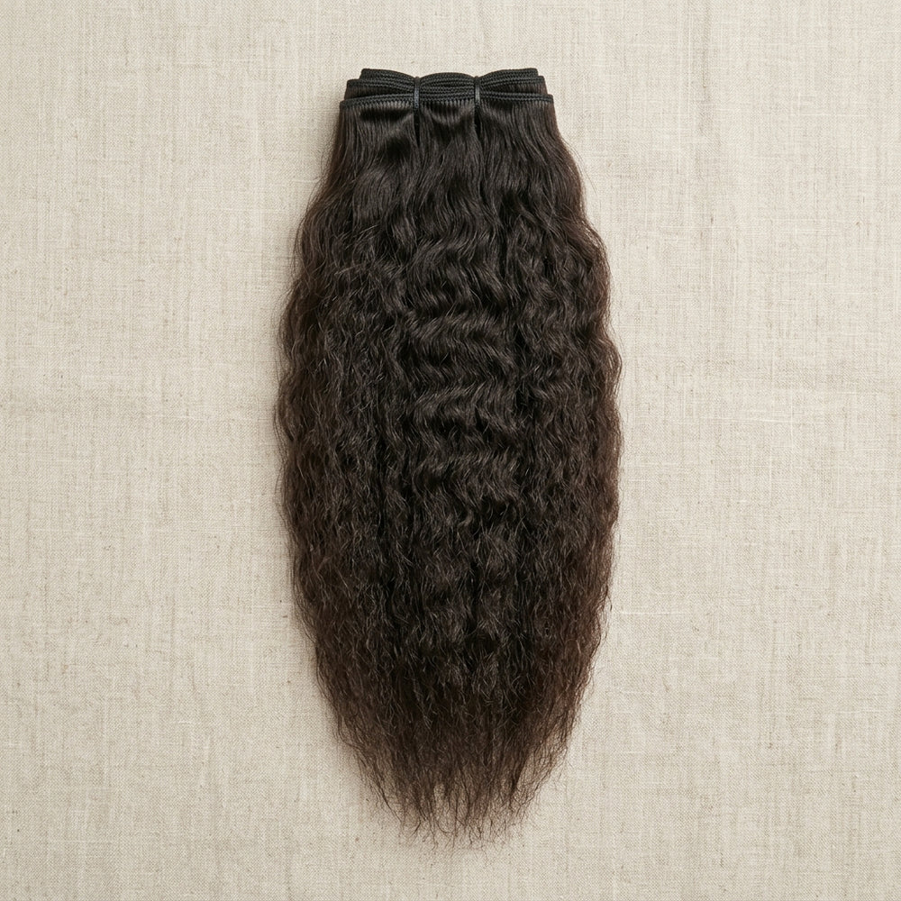 Adéorí Kinky Straight virgin hair extension bundle flat lay on earthy surface